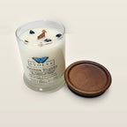 Evolve Botanica Havana Nights 6.5 oz soy sipper candle angled view with wood wick and crystals