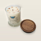 Evolve Botanica Beach & Bamboo 6.5 oz soy sipper candle angled view with wood wick and crystals