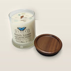 Evolve Botanica Beach Linen 6.5 oz soy sipper candle open with wood lid and crystals