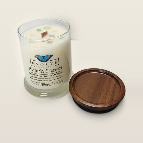 Evolve Botanica Beach Linen 6.5 oz soy sipper candle open with wood lid and crystals