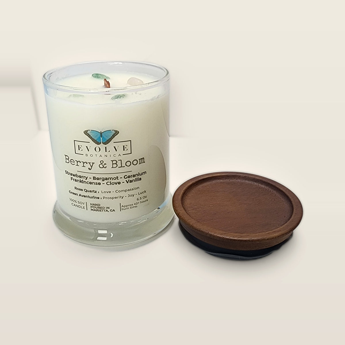 Evolve Botanica Berry & Bloom 6.5 oz soy sipper candle open with wood lid and crystals