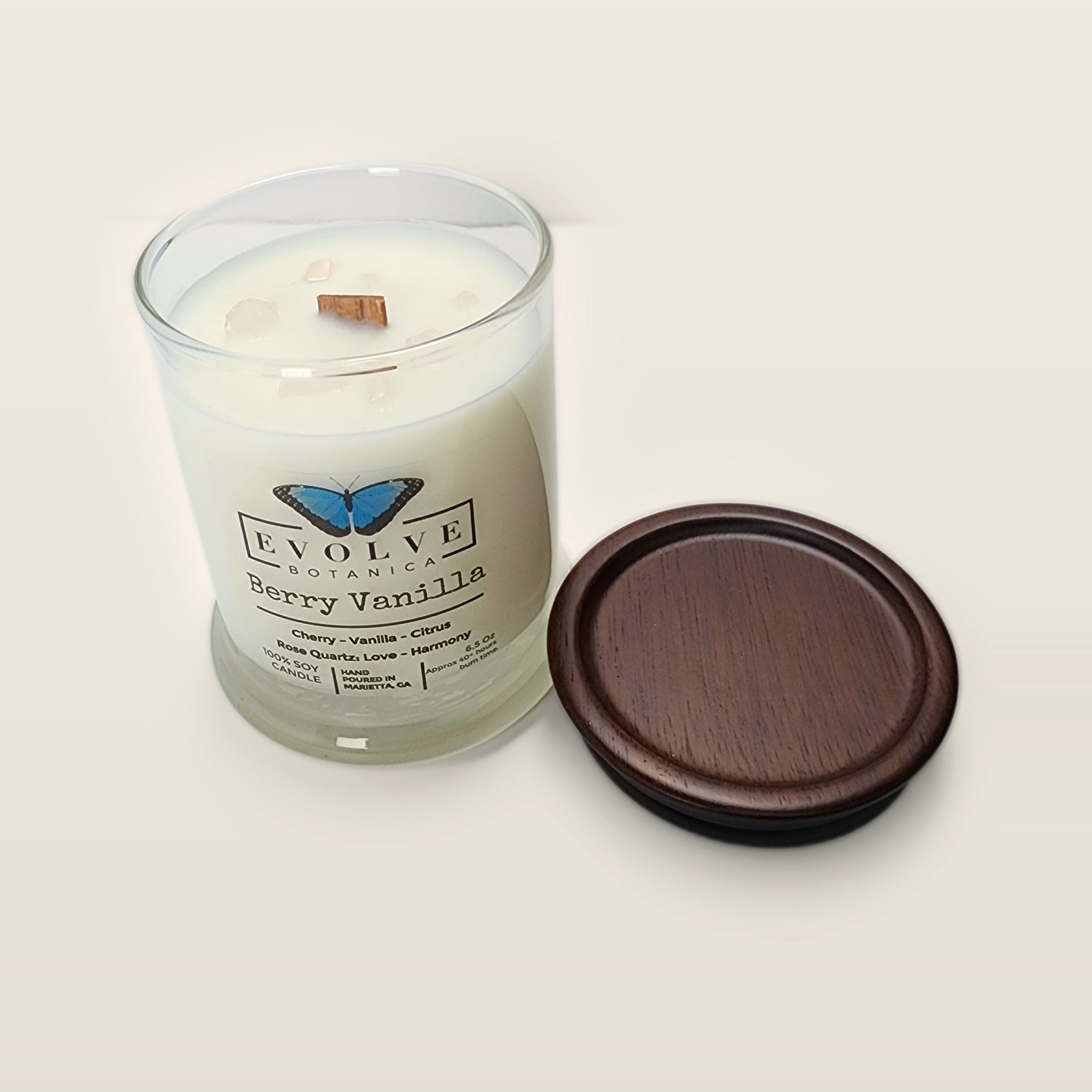 Evolve Botanica Berry Vanilla 6.5 oz soy sipper candle angled view with wood wick and crystals