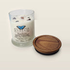 Evolve Botanica Bonfire 6.5 oz soy sipper candle angled view with wood wick and crystals