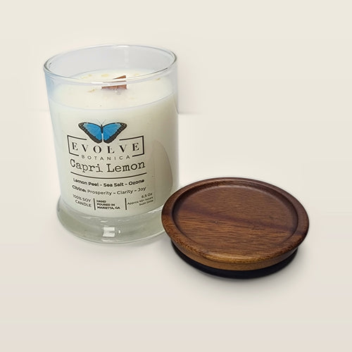 Evolve Botanica Capri Lemon 6.5 oz soy sipper candle open with wood lid and crystals