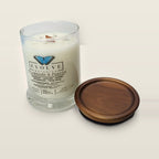 Evolve Botanica Diamonds & Pearls 6.5 oz soy sipper candle open with wood lid and crystals