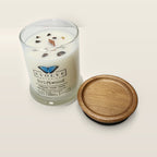 Evolve Botanica Driftwood 6.5 oz soy sipper candle angled view with wood wick and crystals