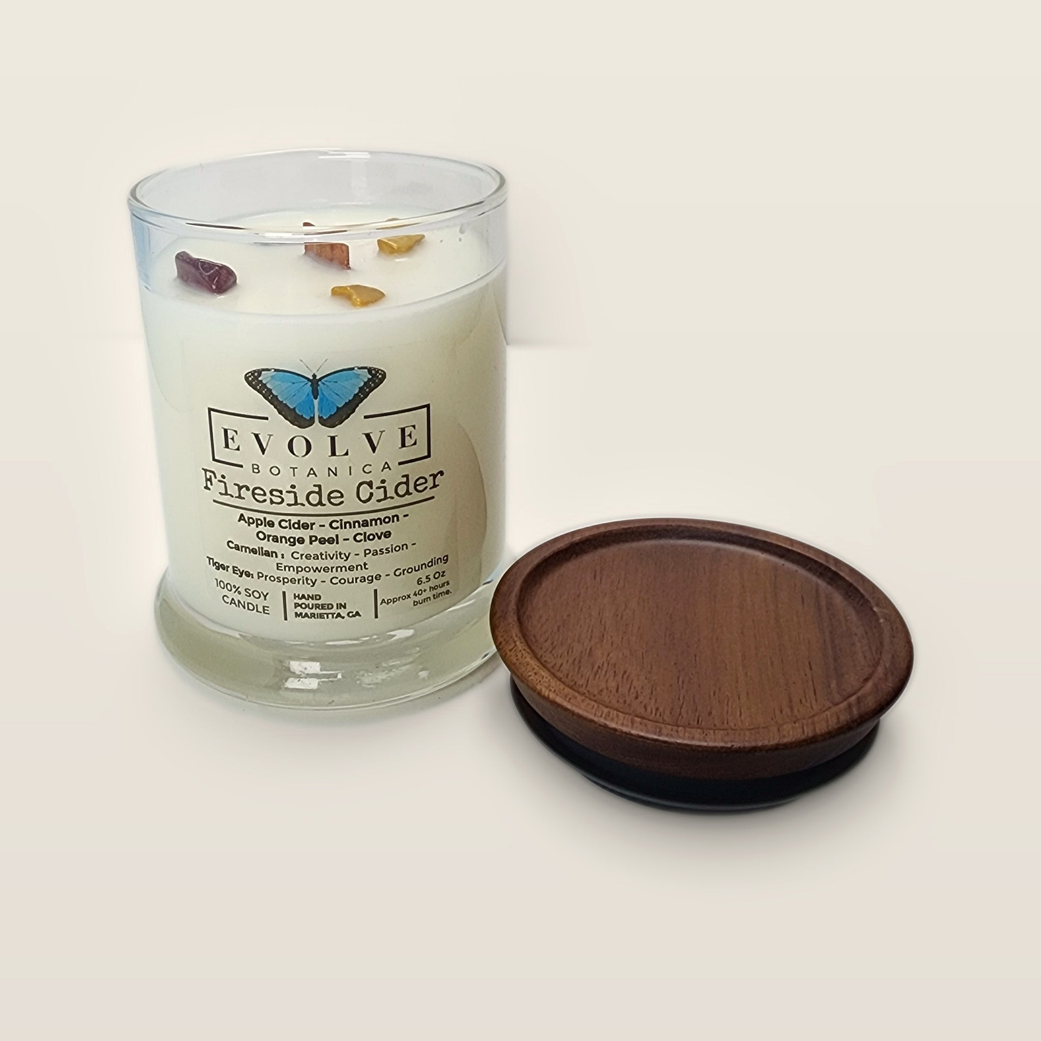 Evolve Botanica Fireside Cider 6.5 oz soy sipper candle open with wood lid and crystals
