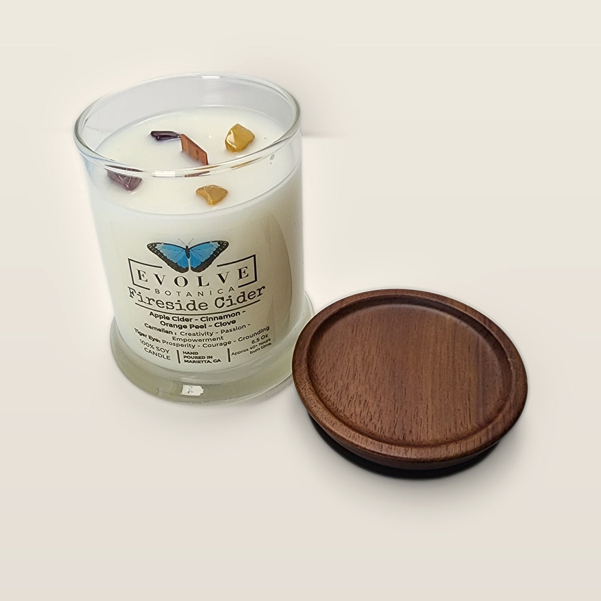 Evolve Botanica Fireside Cider 6.5 oz soy sipper candle angled view with wood wick and crystals