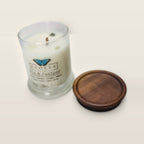 Evolve Botanica Gin & Juniper 6.5 oz soy sipper candle angled view with wood wick and crystals