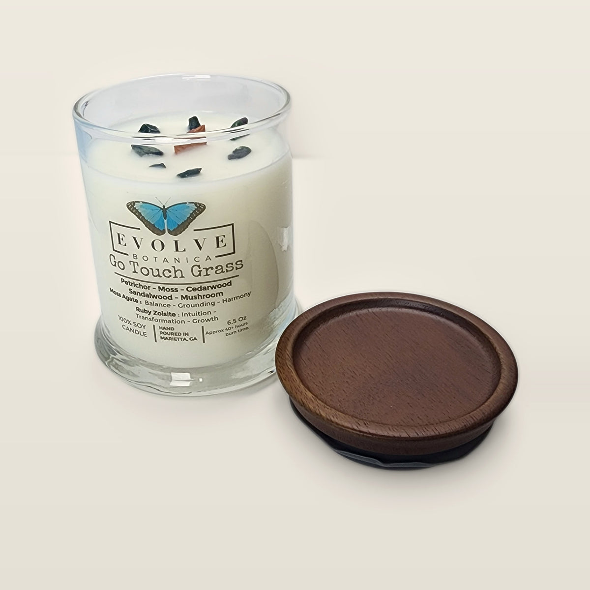 Evolve Botanica Go Touch Grass 6.5 oz soy sipper candle open with wood lid and crystals