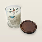 Evolve Botanica Go Touch Grass 6.5 oz soy sipper candle angled view with wood wick and crystals