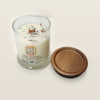 Evolve Botanica Hill Station 6.5 oz soy sipper candle angled view with wood wick and crystals