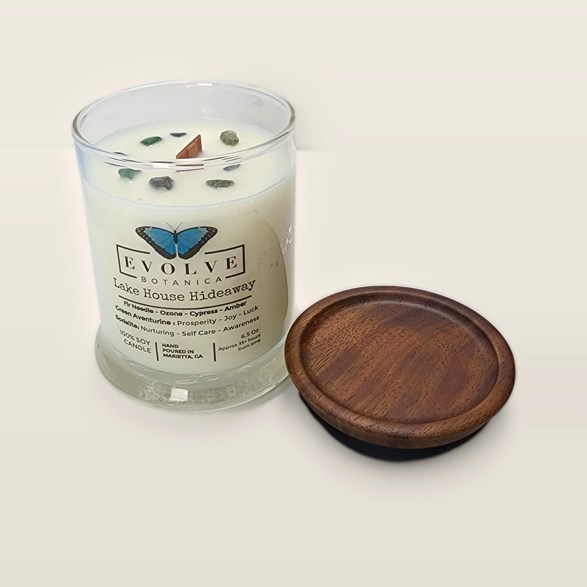 Evolve Botanica Lake House Hideaway 6.5 oz soy sipper candle open with wood lid and crystals