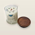 Evolve Botanica Lake House Hideaway 6.5 oz soy sipper candle angled view with wood wick and crystals