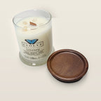 Evolve Botanica Library 6.5 oz soy sipper candle angled view with wood wick and crystals