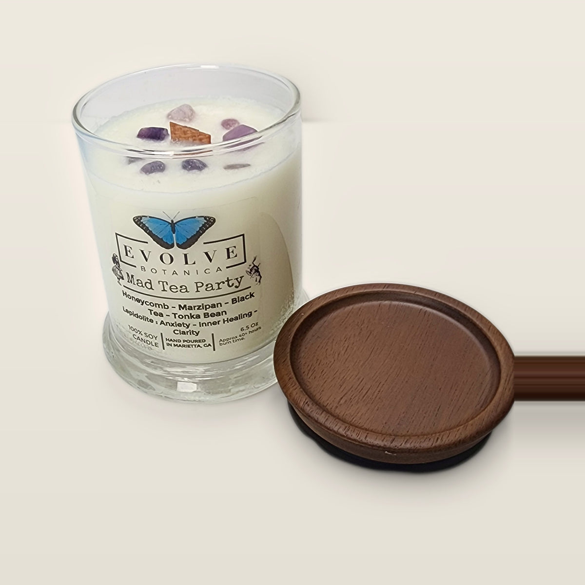Evolve Botanica Mad Tea Party 6.5 oz soy sipper candle open with wood lid and crystals