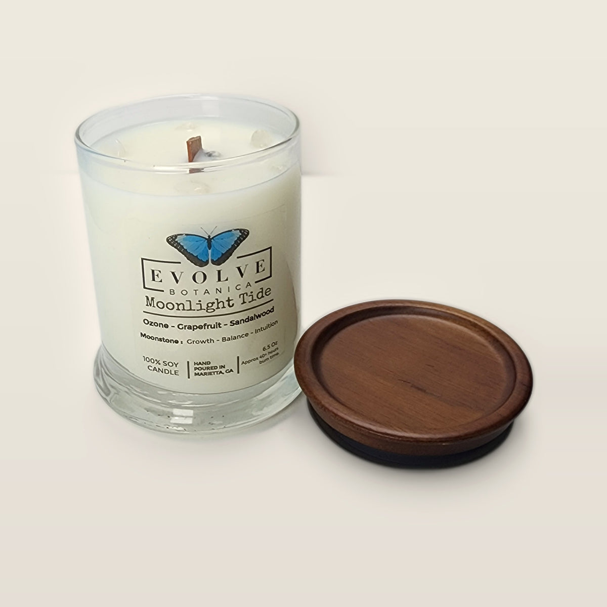 Evolve Botanica Moonlight Tide 6.5 oz soy sipper candle open with wood lid and crystals