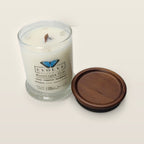 Evolve Botanica Moonlight Tide 6.5 oz soy sipper candle angled view with wood wick and crystals
