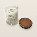 Evolve Botanica Papaya & Paradise 6.5 oz soy sipper candle angled view with wood wick and crystals