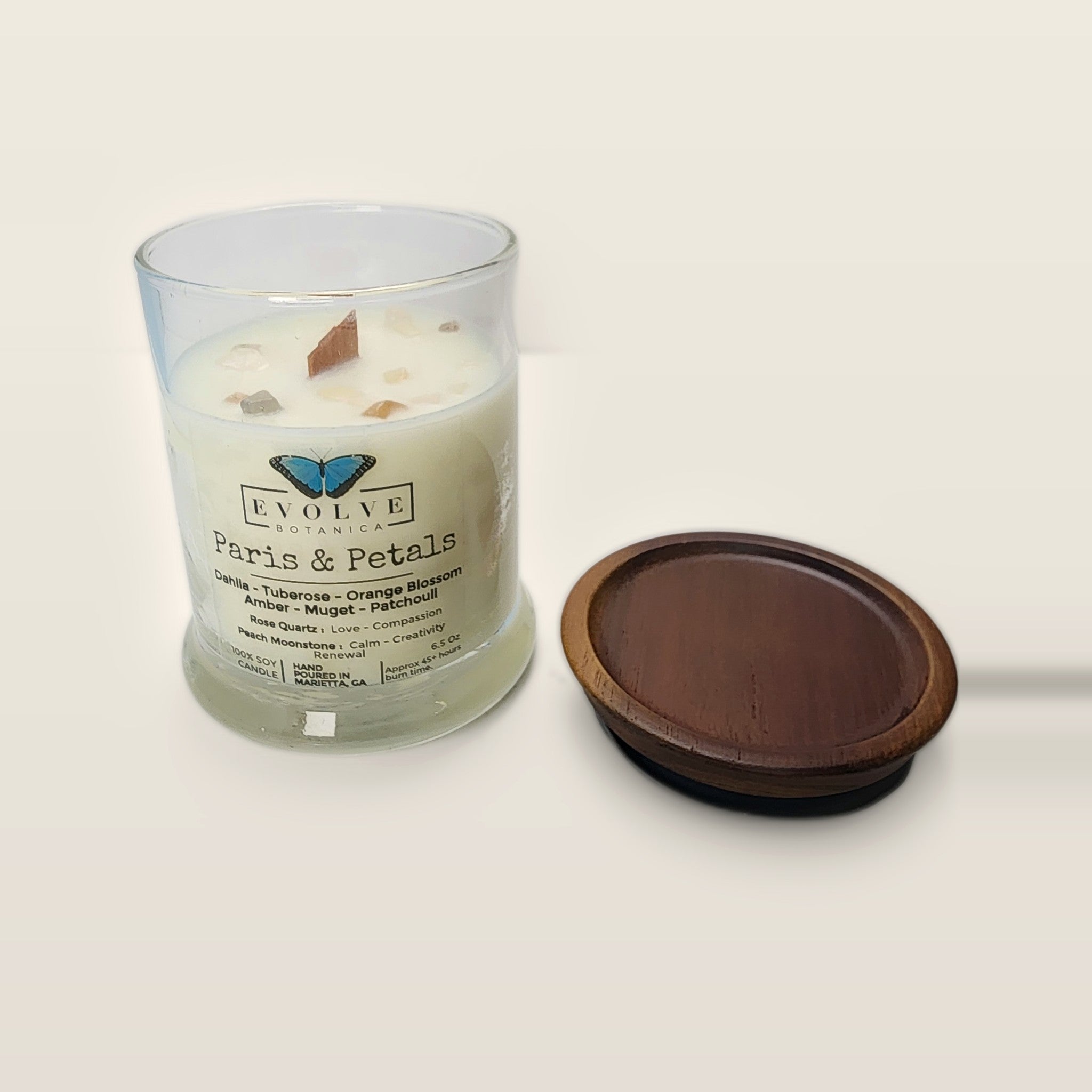 Evolve Botanica Paris & Petals 6.5 oz soy sipper candle open with wood lid and crystals