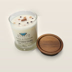 Evolve Botanica Peach & Passion 6.5 oz soy sipper candle angled view with wood wick and crystals