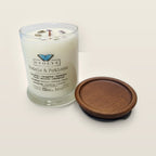 Evolve Botanica Petals & Potions 6.5 oz soy sipper candle open with wood lid and crystals