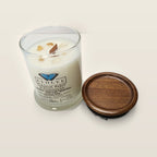 Evolve Botanica Coconut & Pineapple 6.5 oz soy sipper candle angled view with wood wick and crystals