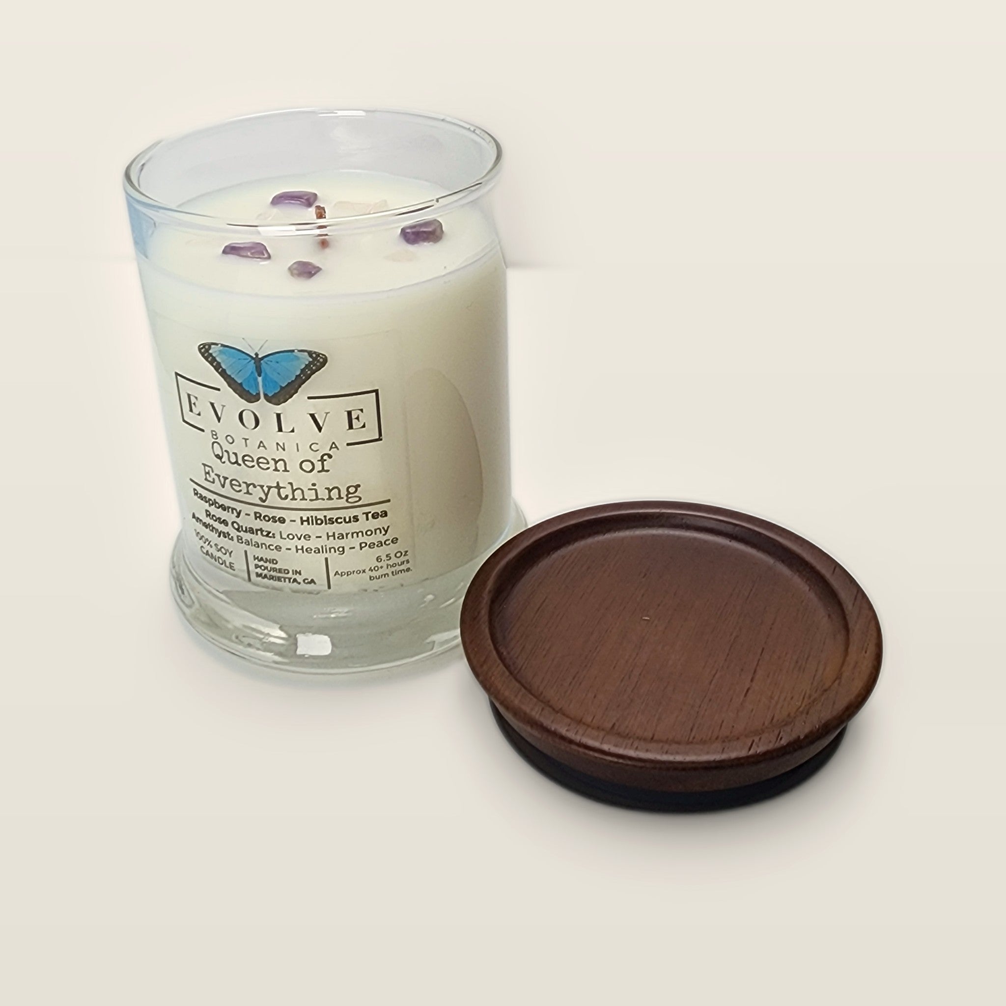 Evolve Botanica Queen of Everything 6.5 oz soy sipper candle open with wood lid and crystals