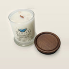 Evolve Botanica Rosewater 6.5 oz soy sipper candle angled view with wood wick and crystals