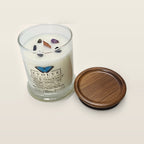 Evolve Botanica Sage & Sanctuary 6.5 oz soy sipper candle angled view with wood wick and crystals