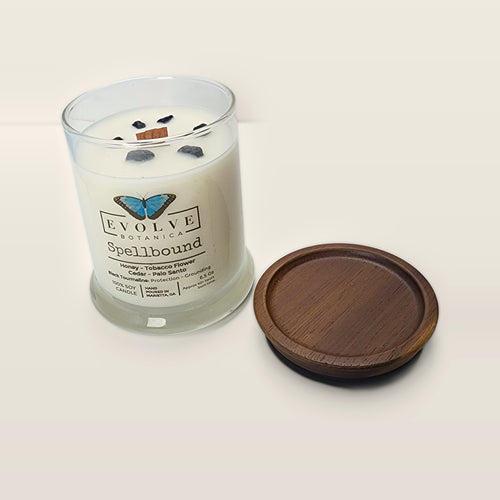 Evolve Botanica Spellbound 6.5 oz soy sipper candle open with wood lid and crystals