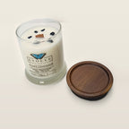 Evolve Botanica Spellbound 6.5 oz soy sipper candle angled view with wood wick and crystals