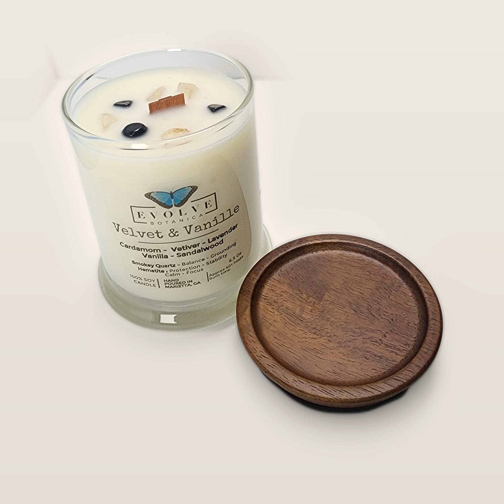 Evolve Botanica Velvet & Vanille 6.5 oz soy sipper candle angled view with wood wick and crystals