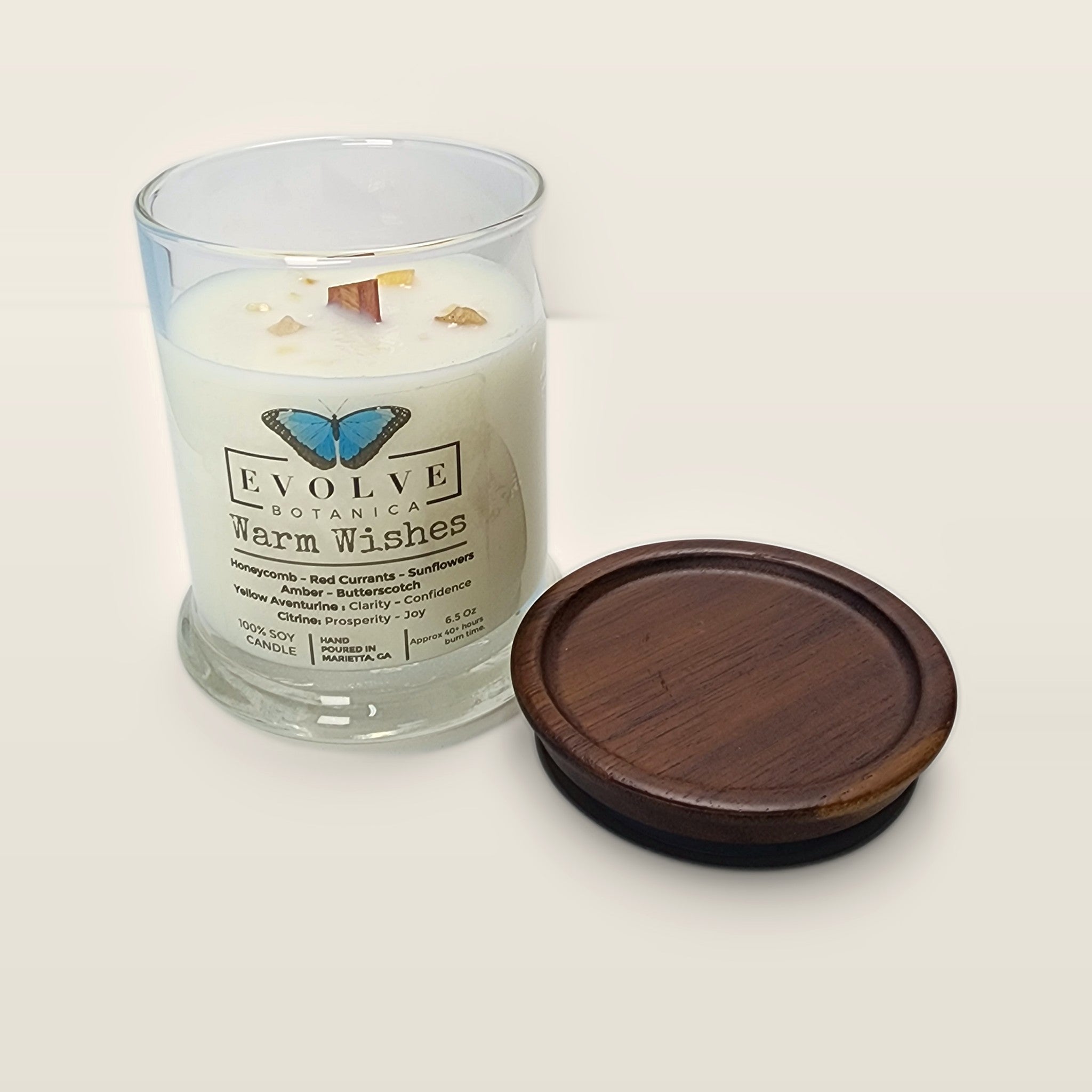 Evolve Botanica Warm Wishes 6.5 oz soy sipper candle open with wood lid and crystals