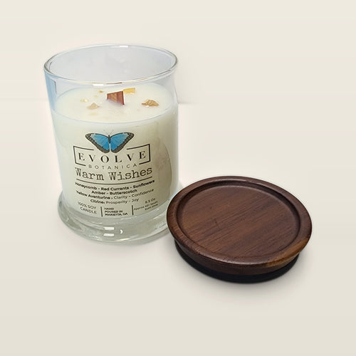 Evolve Botanica Warm Wishes 6.5 oz soy sipper candle open with wood lid and crystals