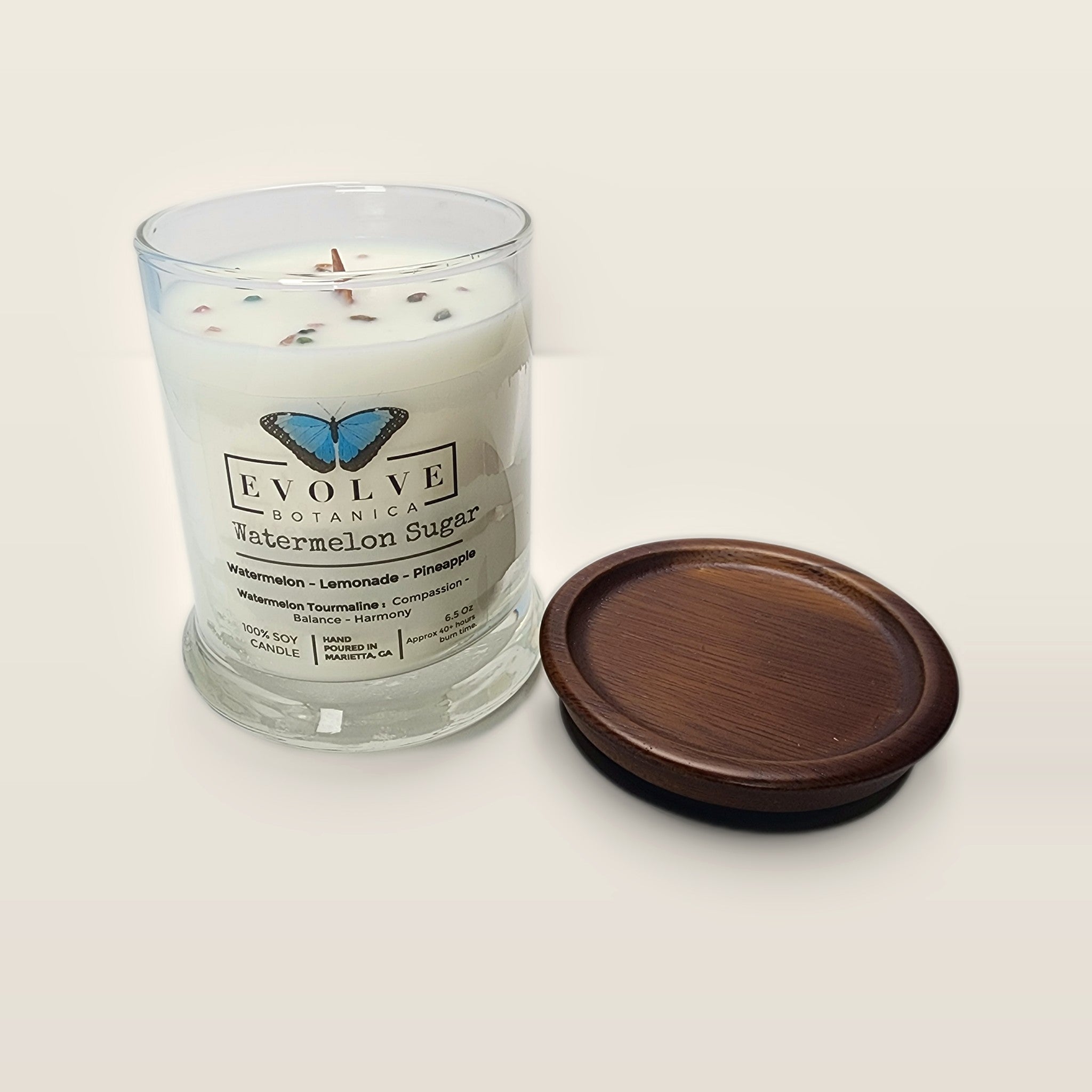 Evolve Botanica Watermelon Sugar 6.5 oz soy sipper candle open with wood lid and crystals