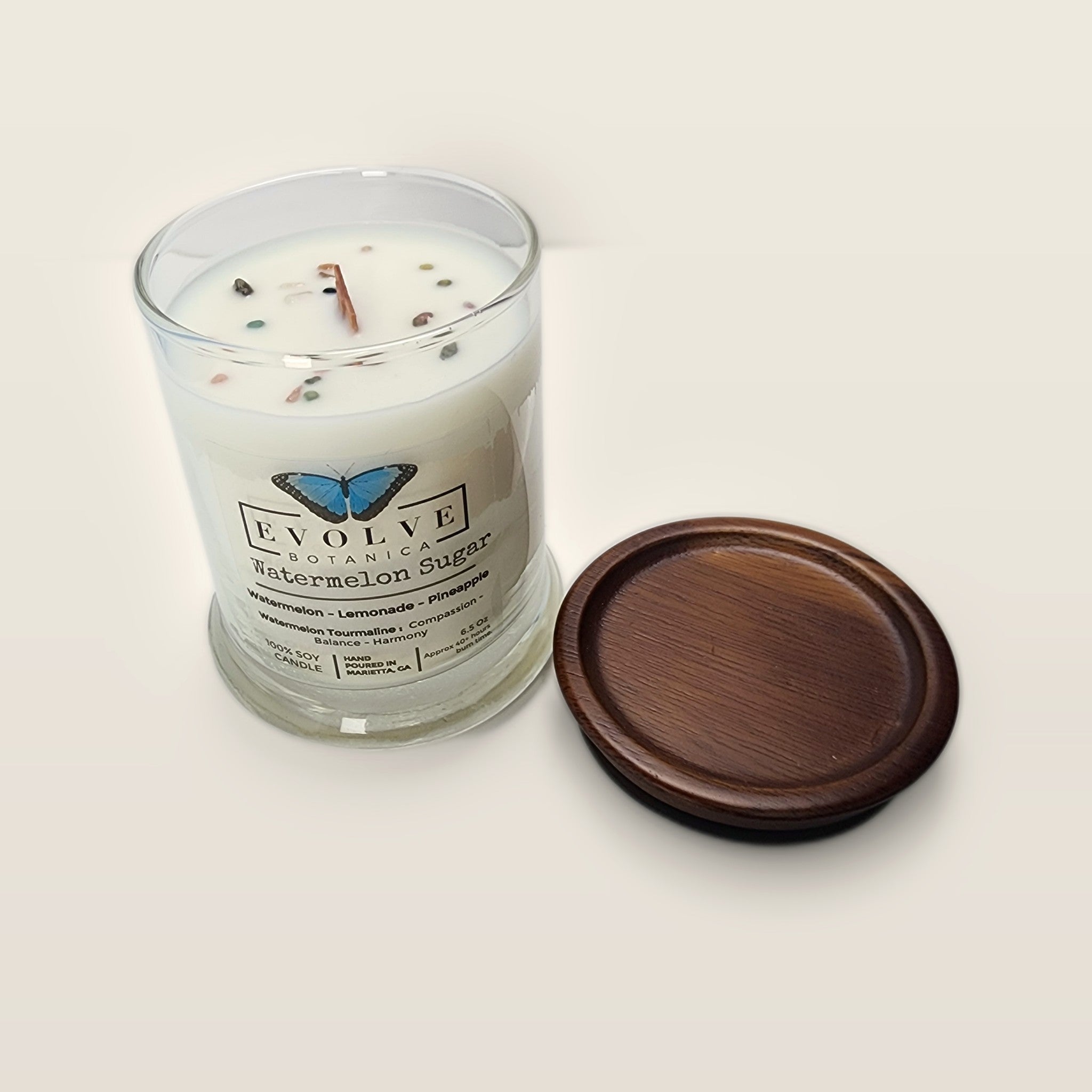 Evolve Botanica Watermelon Sugar 6.5 oz soy sipper candle angled view with wood wick and crystals