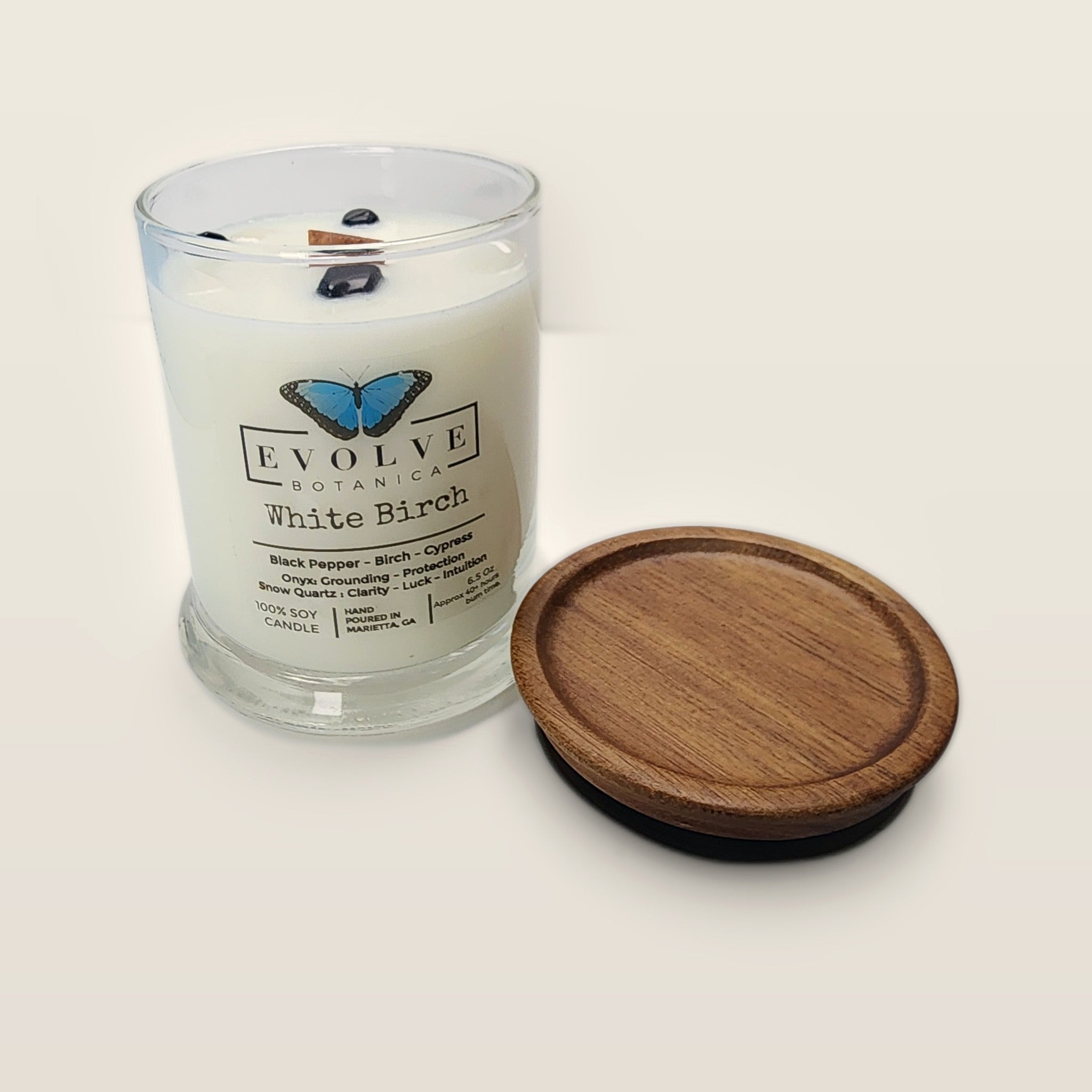 Evolve Botanica White Birch 6.5 oz soy sipper candle open with wood lid and crystals