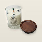 Evolve Botanica Witch Woods 6.5 oz soy sipper candle angled view with wood wick and crystals
