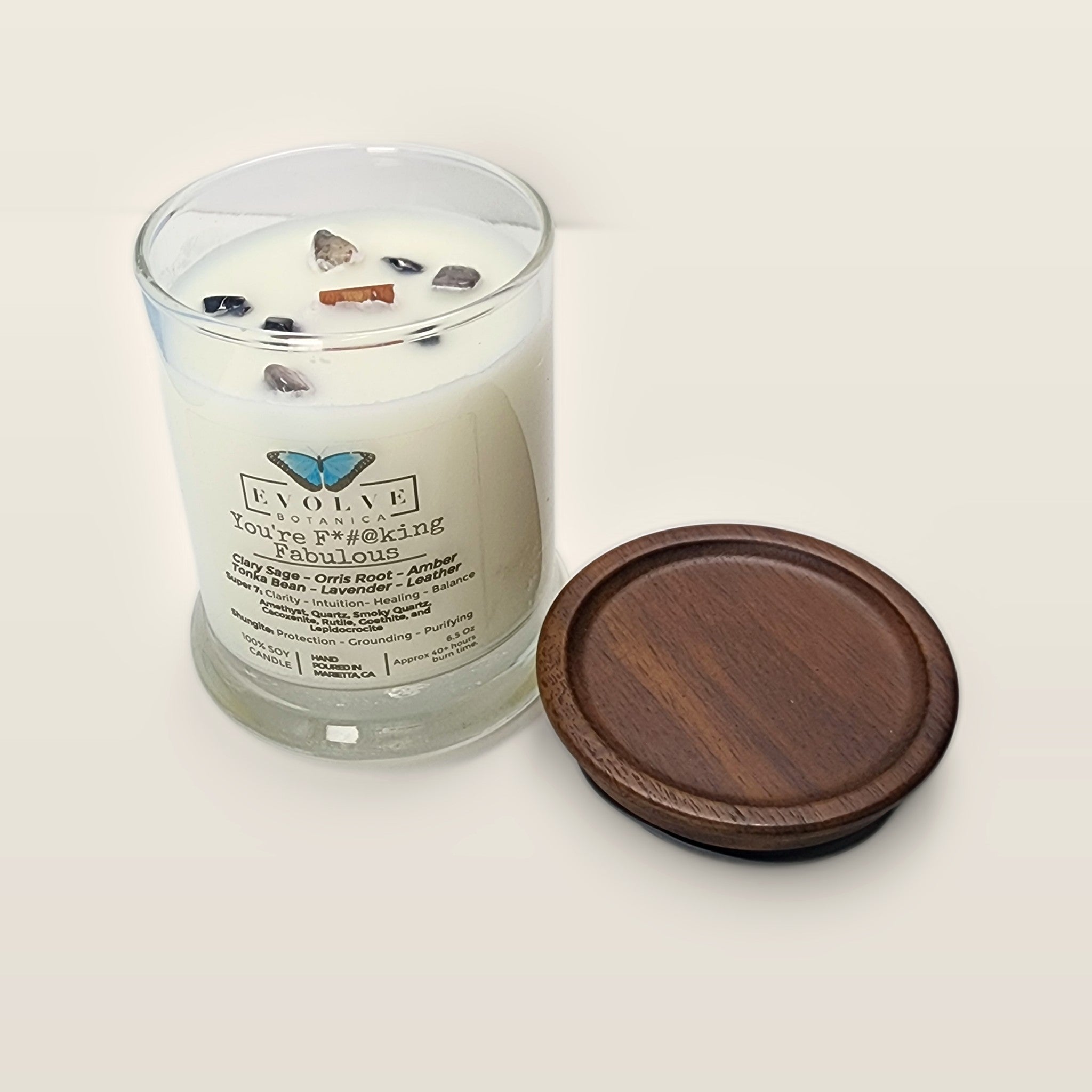 Evolve Botanica You're F#$King Fabulous 6.5 oz soy sipper candle angled view with wood wick and crystals