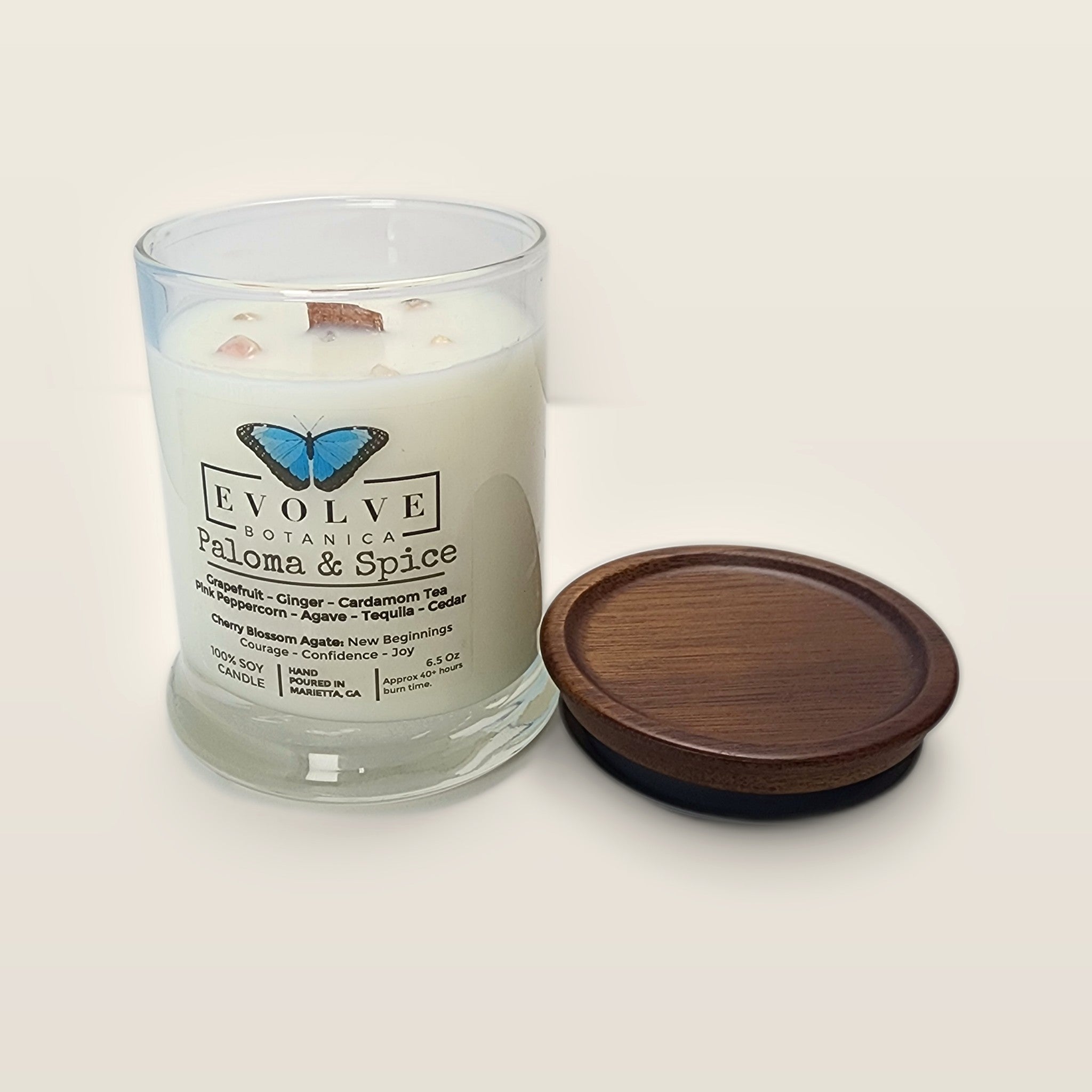 Evolve Botanica Paloma & Spice 6.5 oz soy sipper candle open with wood lid and crystals