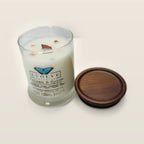 Evolve Botanica Paloma & Spice 6.5 oz soy sipper candle angled view with wood wick and crystals