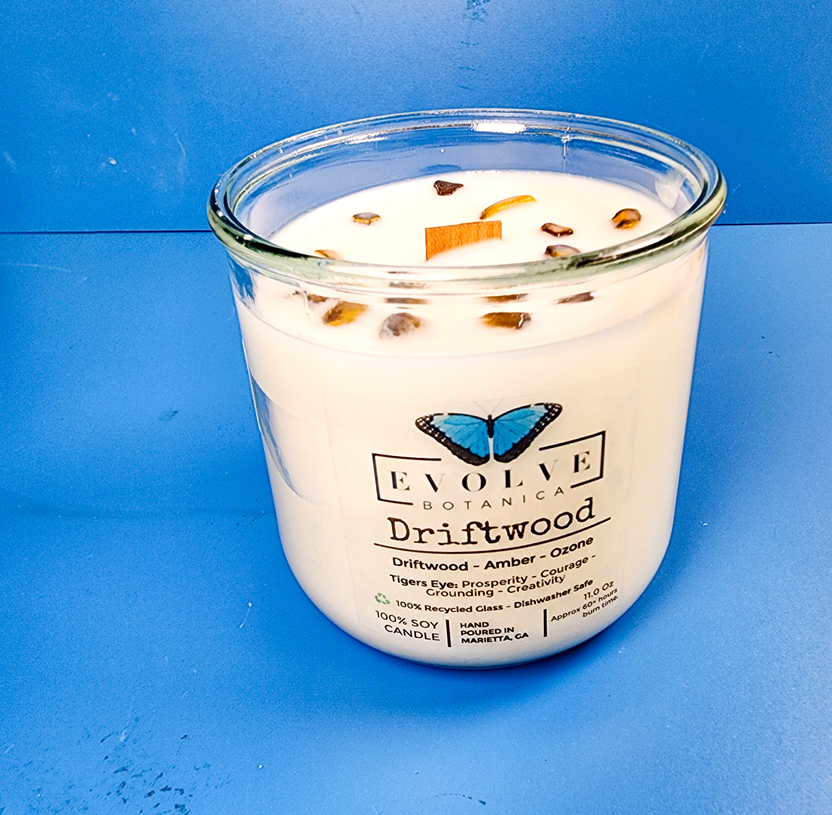 Driftwood Rocks candle styled with coastal accents — beach house home decor