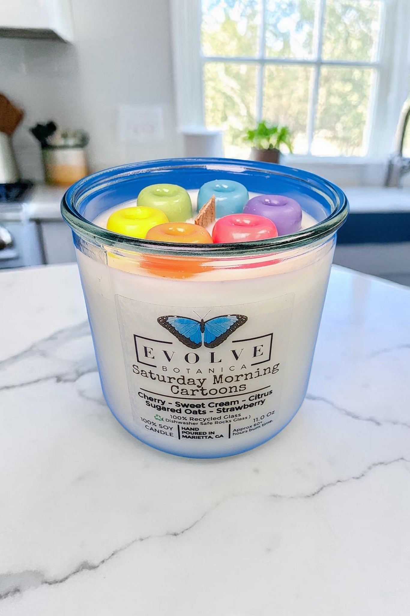Cereal scented soy candle styled on a kitchen counter with a bowl of cereal and morning light
