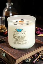 Spellbound wood wick soy candle lit — cozy amber, vanilla bean & cedar atmosphere