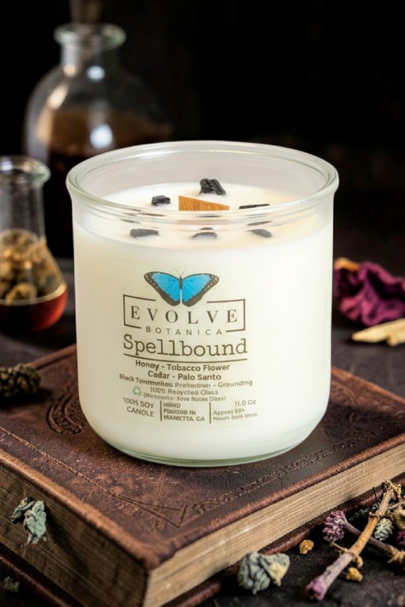 Spellbound wood wick soy candle lit — cozy amber, vanilla bean & cedar atmosphere