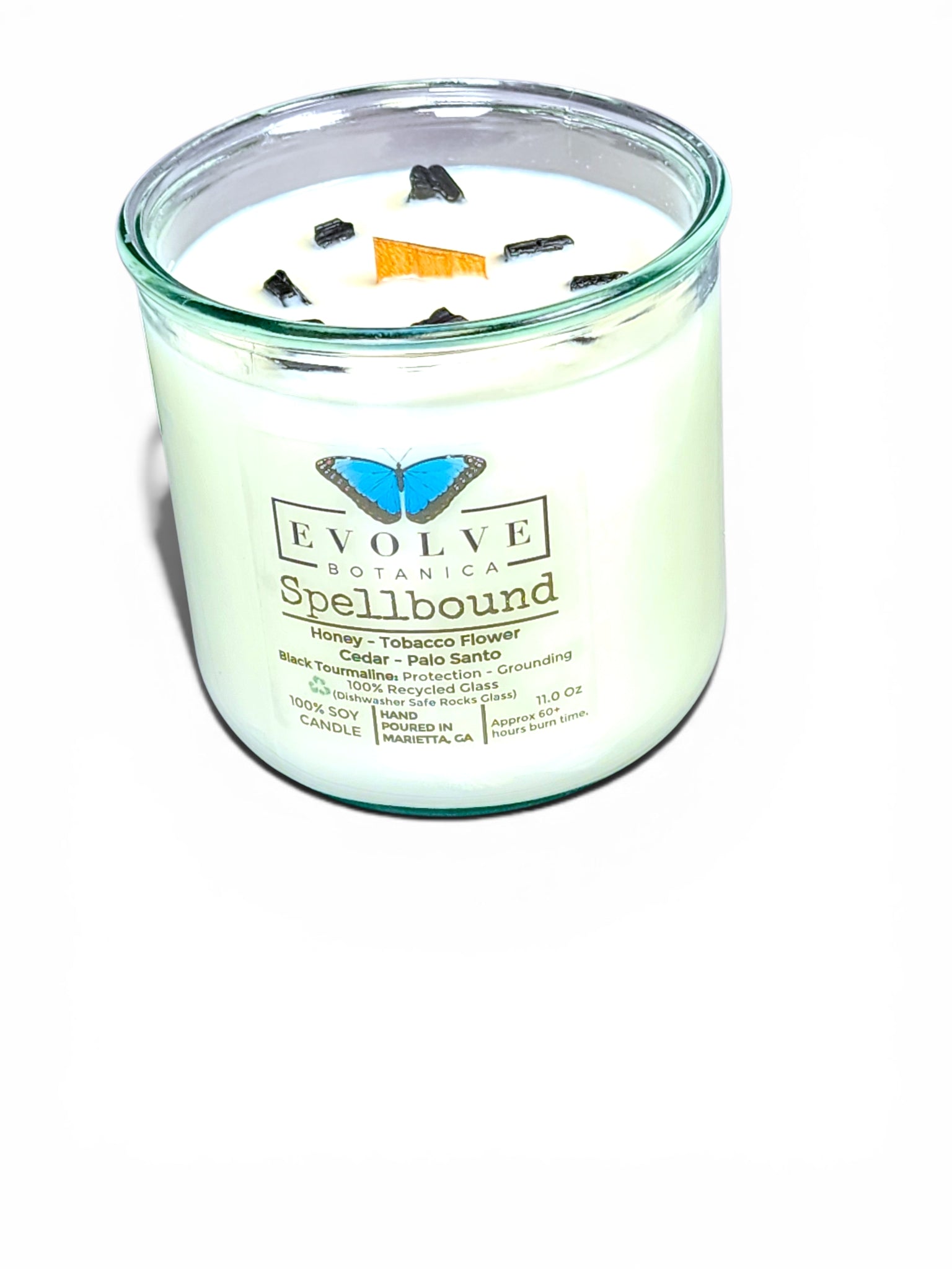 Spellbound Rocks candle styled with amber accents and crystals — witchy home decor