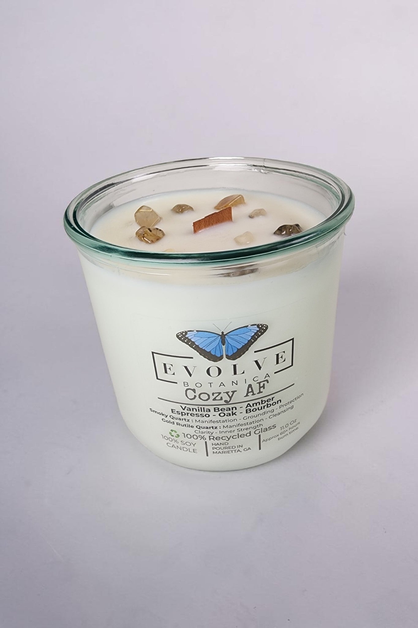 Evolve Botanica Cozy AF Rocks Candle — wood wick soy candle topped with Gold Rutilated Quartz and Smoky Quartz, scented with espresso, bourbon, amber, oak and vanilla bean