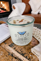 Evolve Botanica Cozy AF Rocks Candle — wood wick soy candle topped with Gold Rutilated Quartz and Smoky Quartz, scented with espresso, bourbon, amber, oak and vanilla bean