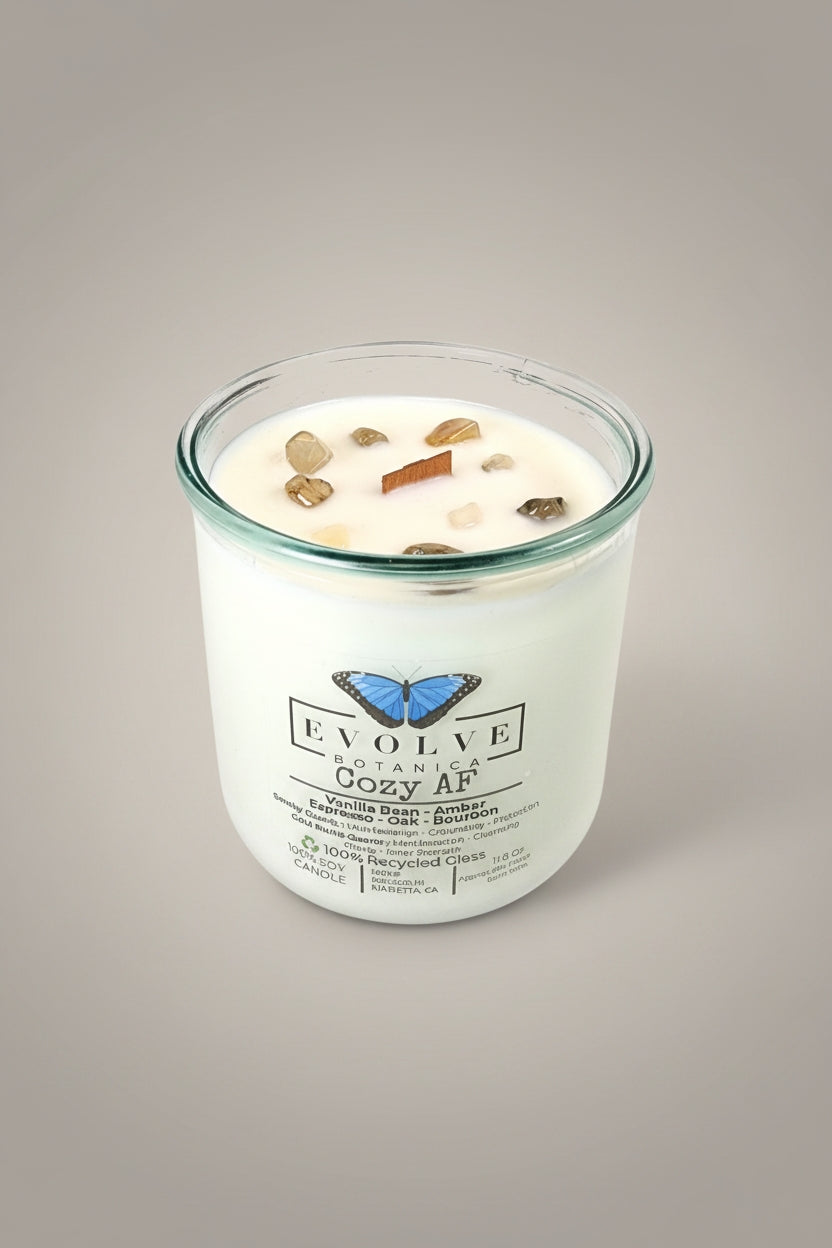 Evolve Botanica Cozy AF Rocks Candle — wood wick soy candle topped with Gold Rutilated Quartz and Smoky Quartz, scented with vanilla bean, amber, espresso, oak and bourbon